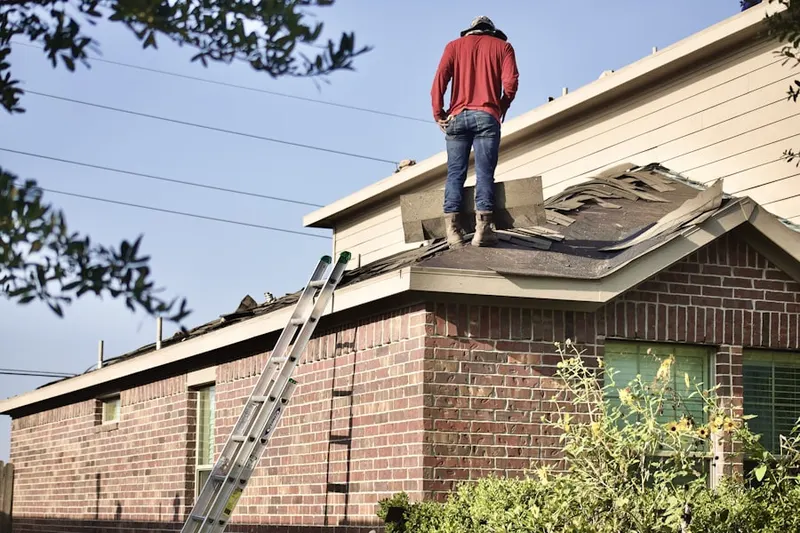 Professional roofer working on a residential roof in Parktowne Industrial Center